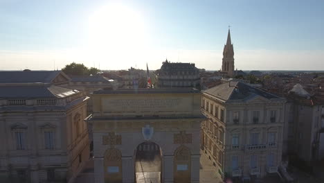 Montpellier-Ecusson-top-to-bottom-aerial-travelling,-ray-of-sunlight-on-the-Arc